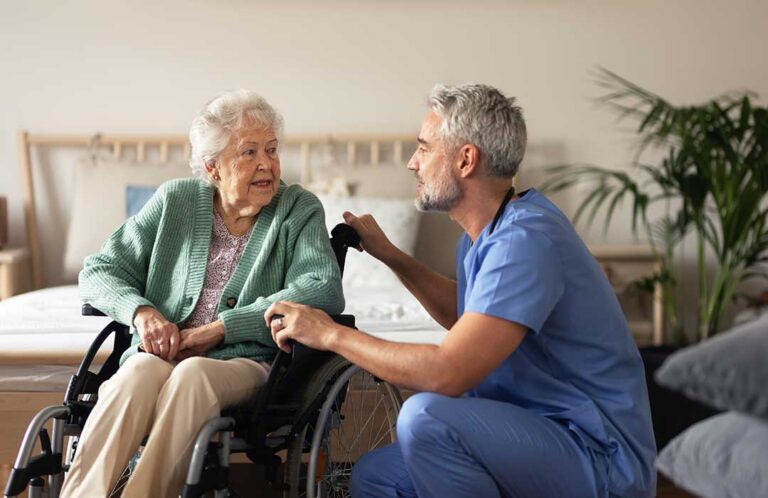 Older adults enjoying a group activity in a comfortable communal living space with natural light and homey furnishings.